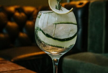Modular Sofas - A gin and tonic on a wooden table with a slice of cucumber