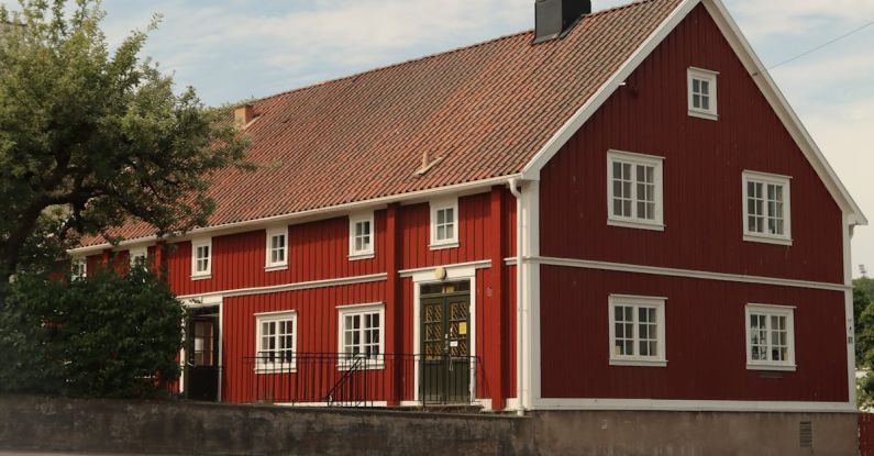 Sliding Panels - A red house with a white roof and a red door