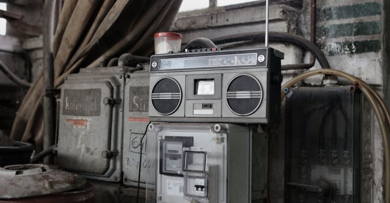 Storage System - Old fashioned cassette player placed in shabby garage near old industrial equipment