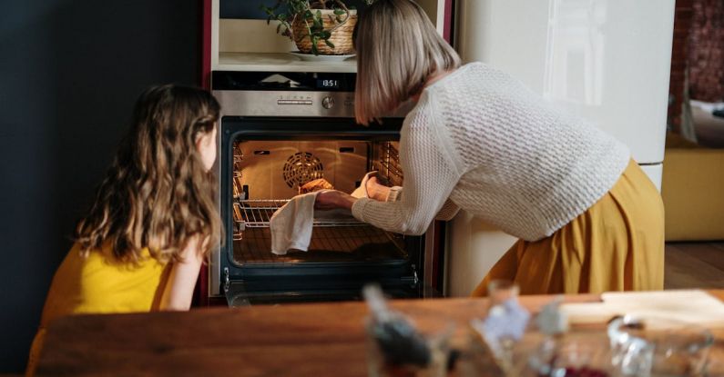 Oven - Woman in White Sweater Baking Cake
